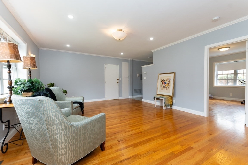 121 Lake Shore Road, Unit 2 Boston, MA 02135 - Photo 7 of 32 a living room with furniture and a wooden floor