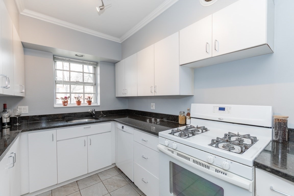 121 Lake Shore Road, Unit 2 Boston, MA 02135 - Photo 10 of 32 a kitchen with white cabinets and appliances