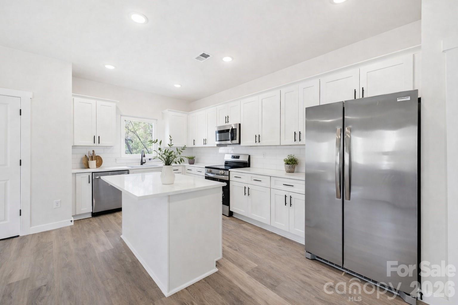 2332 Merts Way Hudson, NC 28638 - Photo 1 of 21 a kitchen with white cabinets and stainless steel appliances