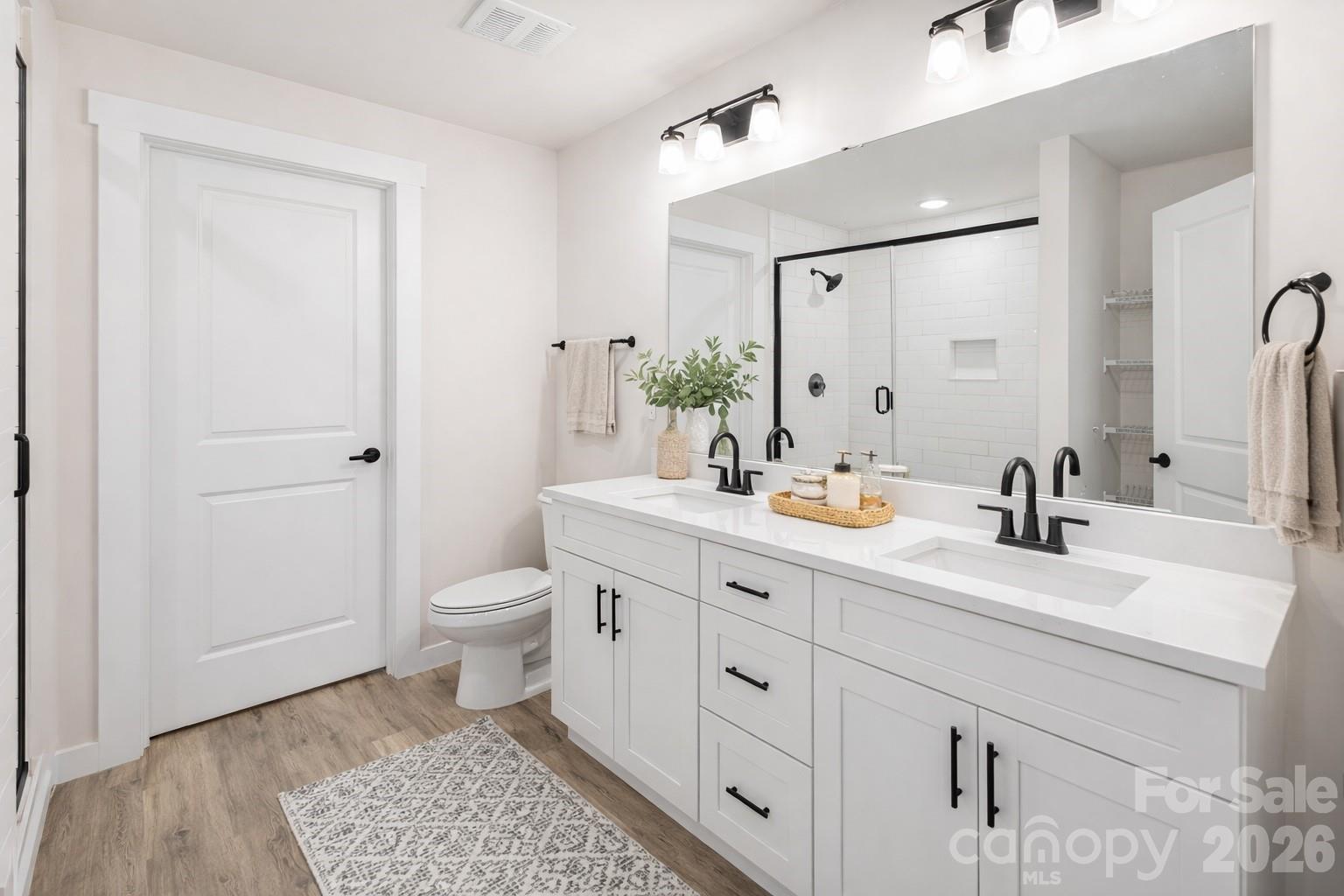 2332 Merts Way Hudson, NC 28638 - Photo 12 of 21 a spacious bathroom with a double vanity sink toilet and shower