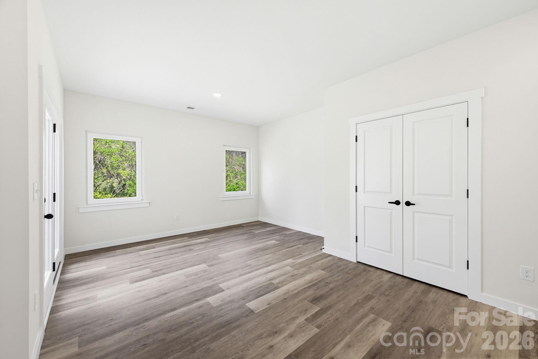 2332 Merts Way Hudson, NC 28638 - Photo 14 of 21 a view of an empty room with wooden floor and a window