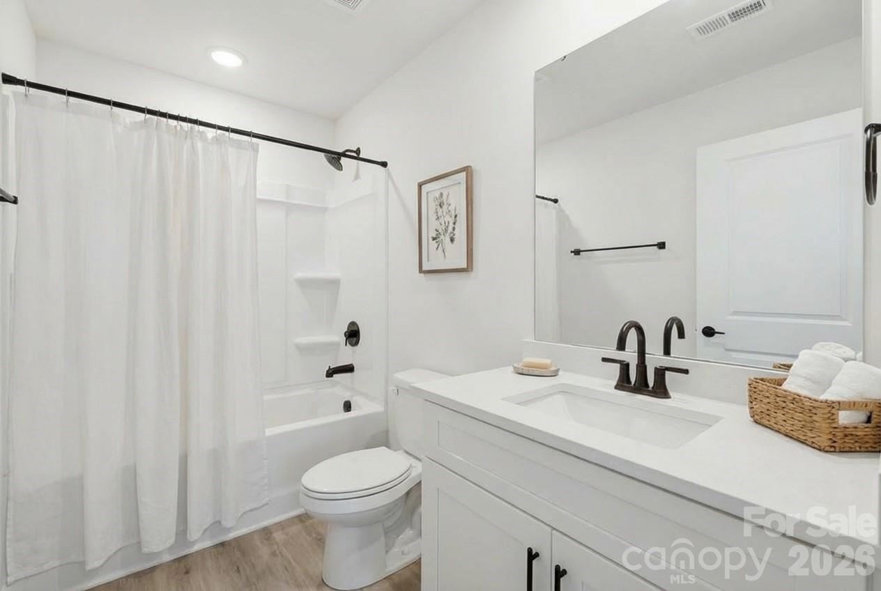 2332 Merts Way Hudson, NC 28638 - Photo 15 of 21 a bathroom with a sink a toilet and shower curtain