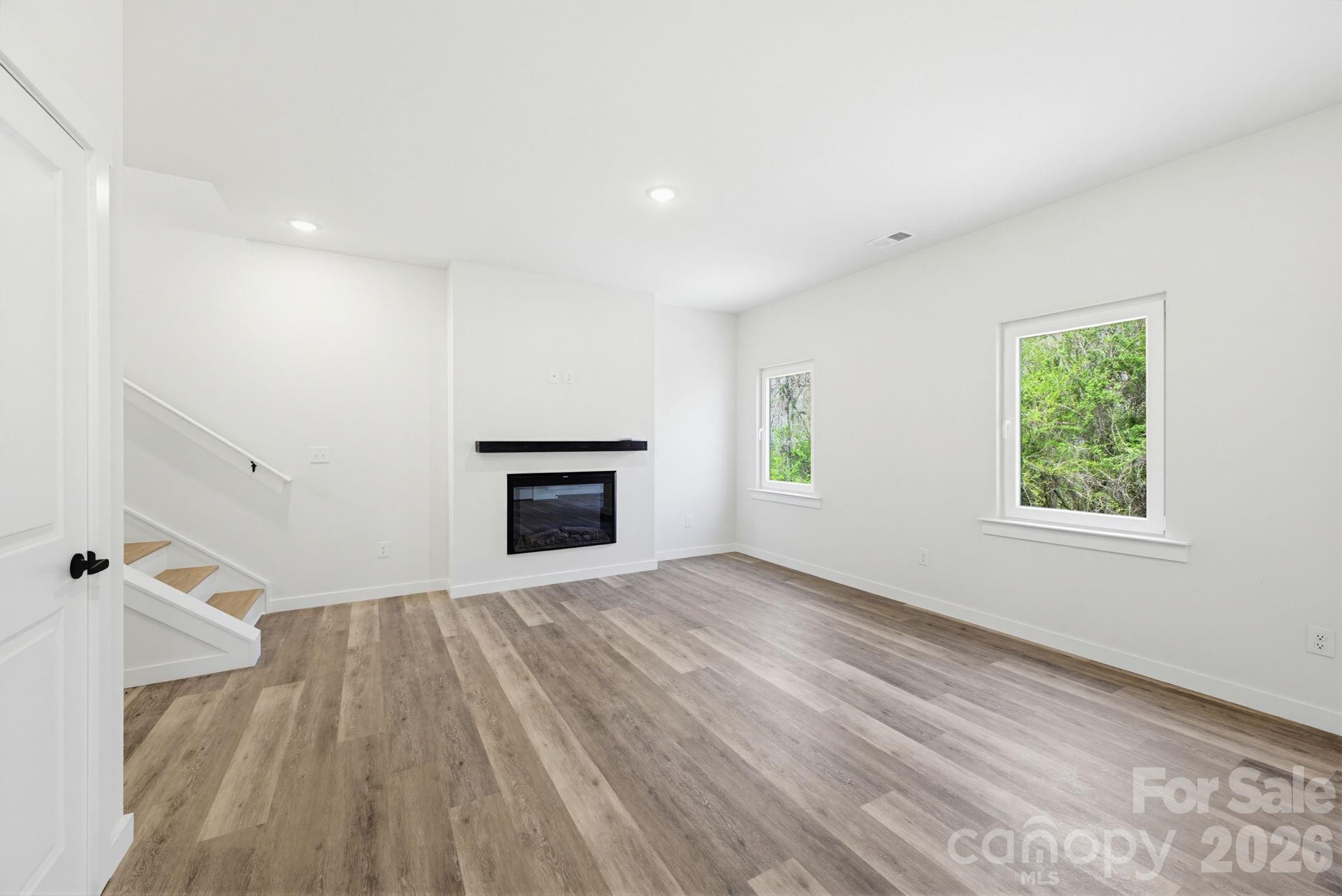 2332 Merts Way Hudson, NC 28638 - Photo 6 of 21 wooden floor in an empty room with a window