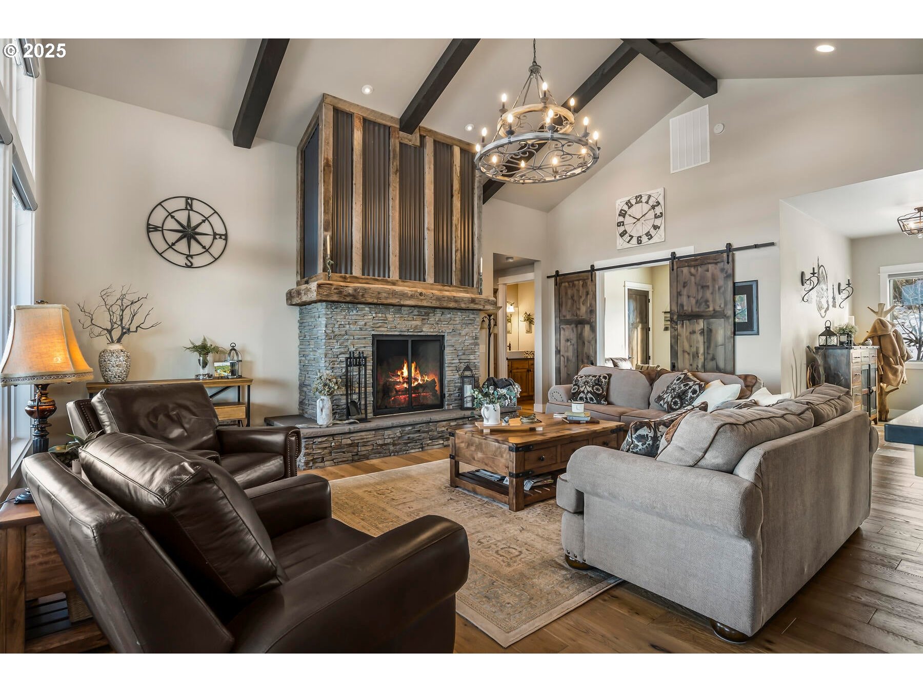 16368 South W Hat Rock Loop Powell Butte, OR 97753 - Photo 13 of 40 a living room with furniture a fireplace and a chandelier