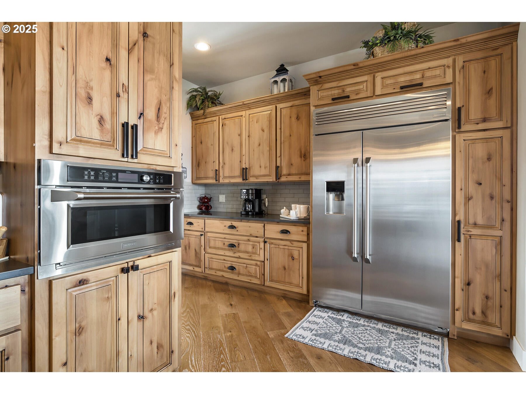 16368 South W Hat Rock Loop Powell Butte, OR 97753 - Photo 23 of 40 a kitchen with stainless steel appliances kitchen island granite countertop a refrigerator and a stove top oven