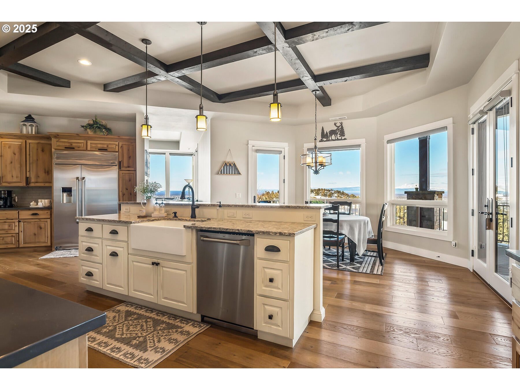 16368 South W Hat Rock Loop Powell Butte, OR 97753 - Photo 25 of 40 a kitchen with stainless steel appliances kitchen island granite countertop a sink and cabinets
