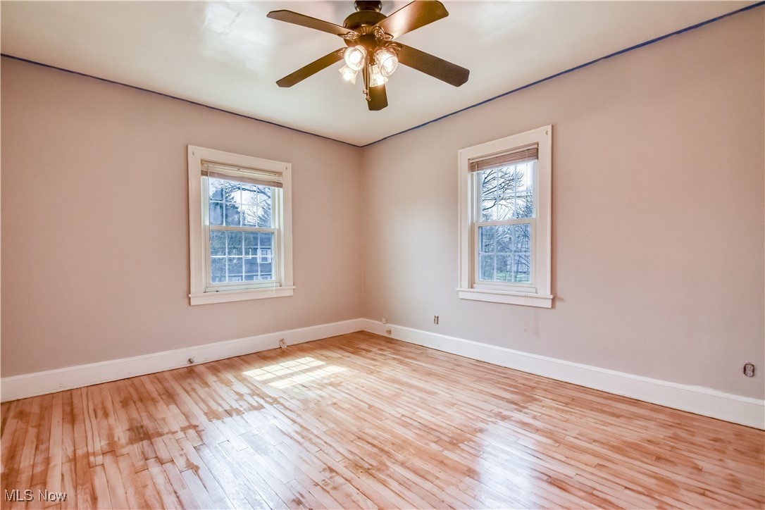 3733 East Antisdale Road Cleveland, OH 44118 - Photo 18 of 28 Unfurnished room with baseboards, ceiling fan, and wood-type flooring