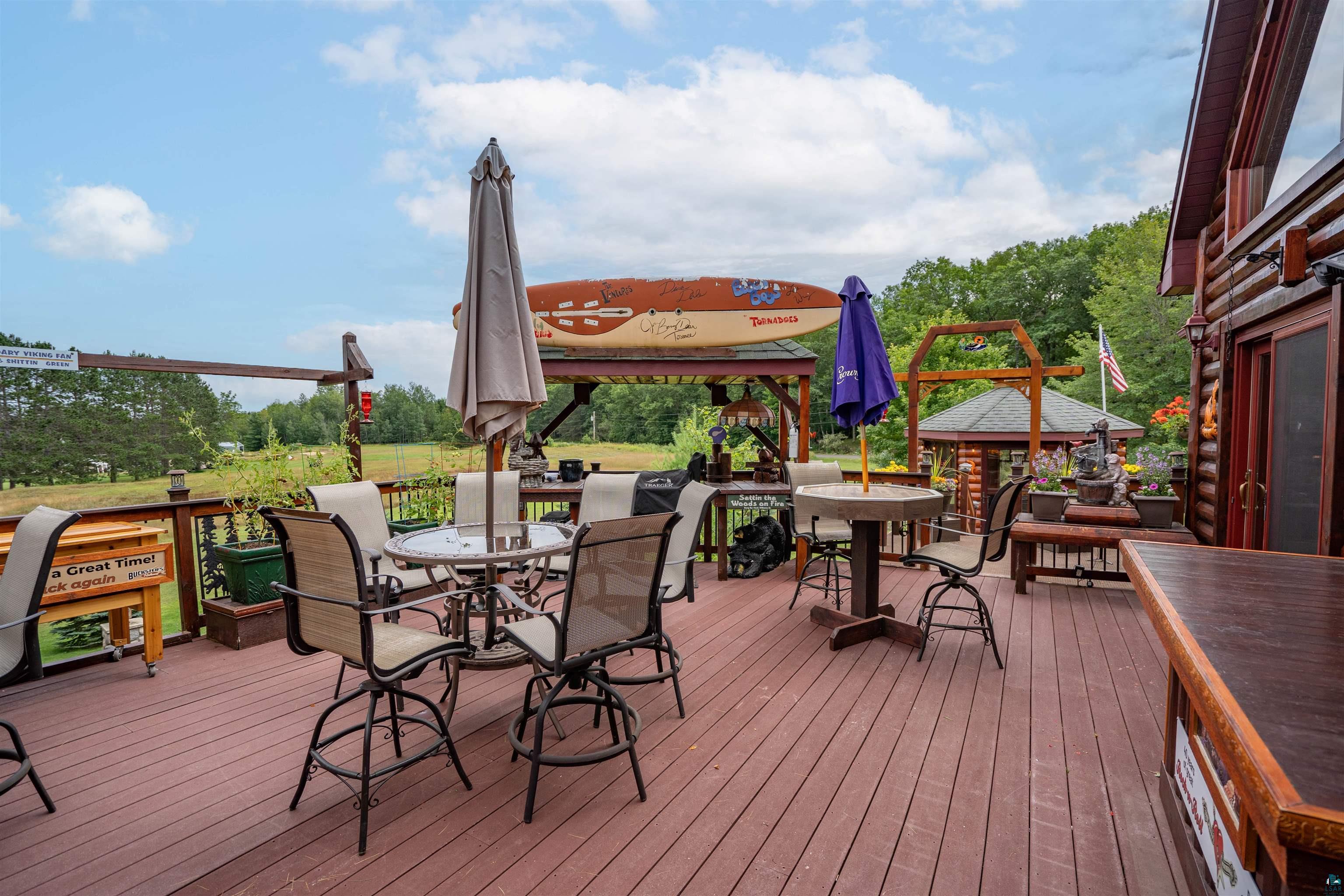 11911 East Rowe Road Lake Nebagamon, WI 54849 - Photo 37 of 61 Expansive outdoor deck featuring composite decking and a wooden railing