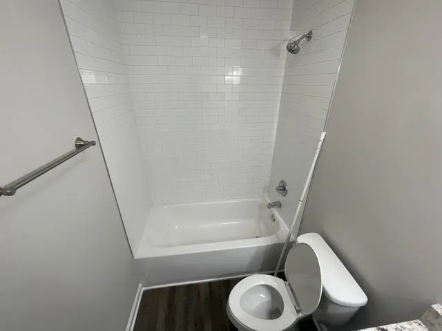 a bathroom with a toilet and a bathtub