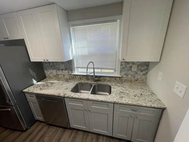 a kitchen with a sink and cabinets