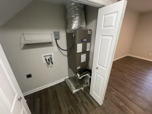 a room with gym equipment and wooden floor