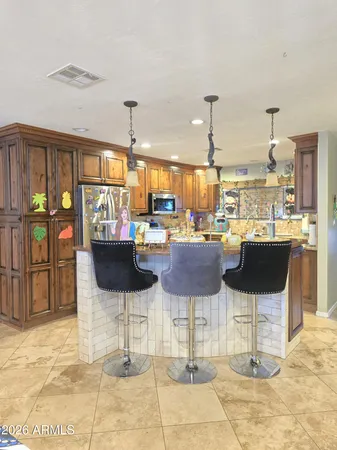 a kitchen with stainless steel appliances granite countertop a stove sink and cabinets