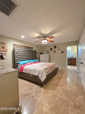 a spacious bedroom with a bed and a cabinets