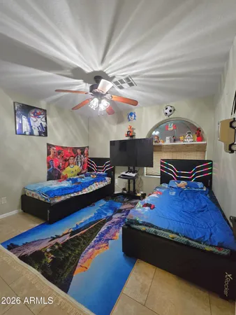 a bedroom with furniture and a baby crib