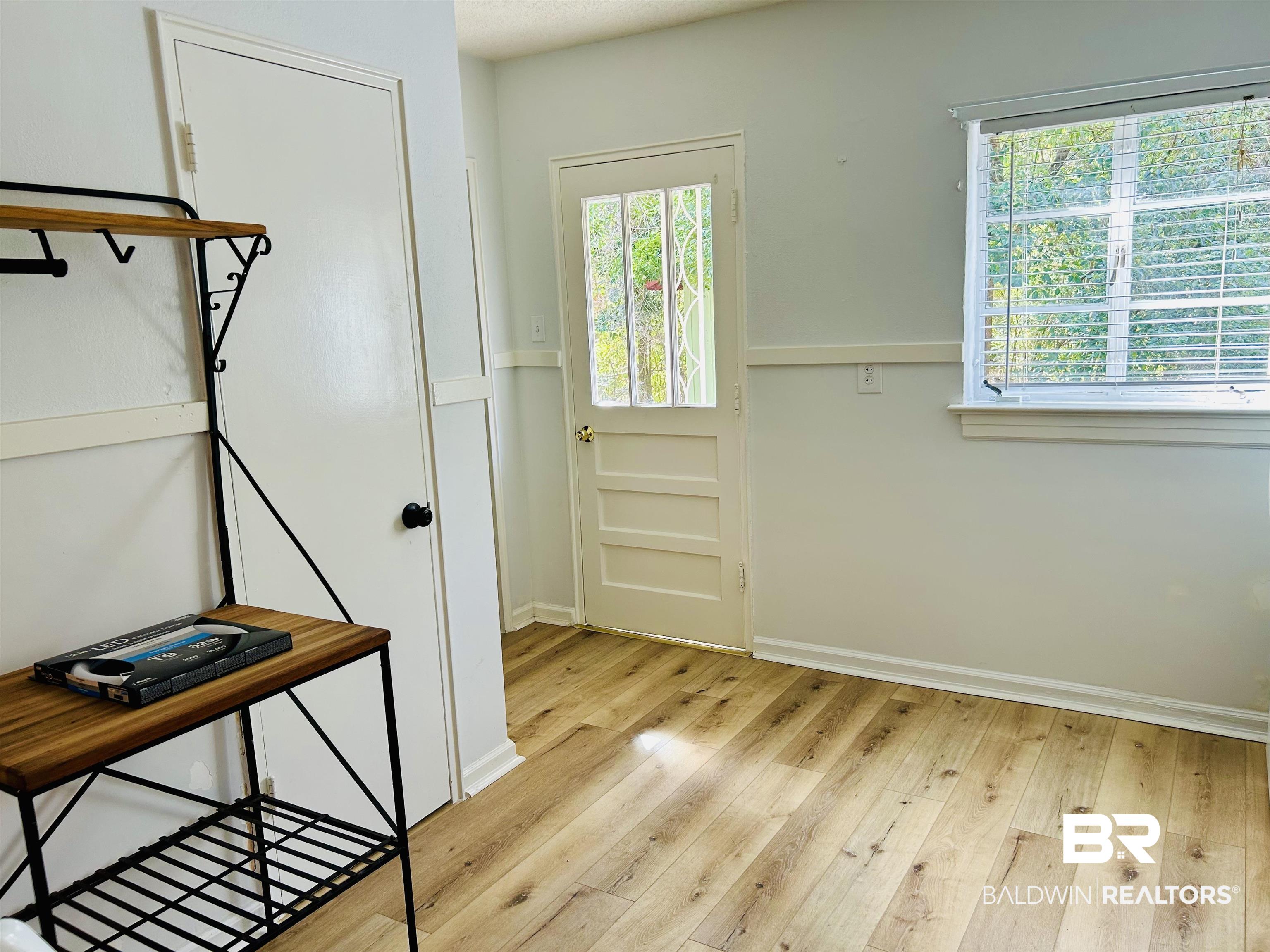 94 Diamond Street Mobile, AL 36611 - Photo 11 of 30 Doorway to outside featuring light hardwood / wood-style floors