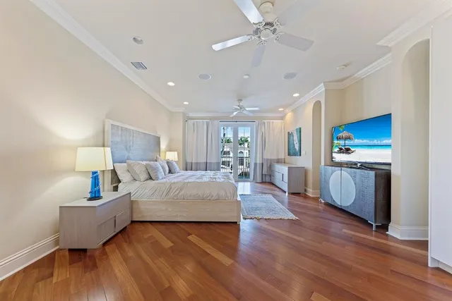 a bedroom with a large bed and a chandelier