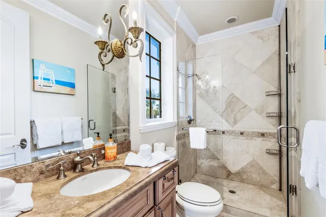 a spacious bedroom with a large bed and a chandelier