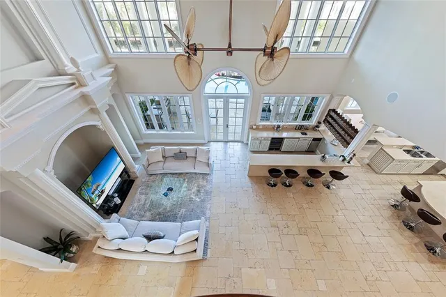 a view of a patio with couple of couches and potted plants