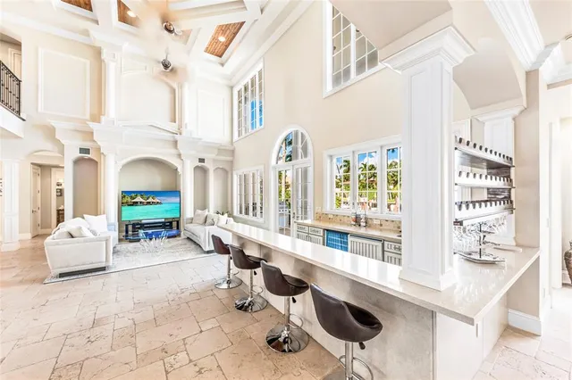 a living room with furniture a fireplace and large windows