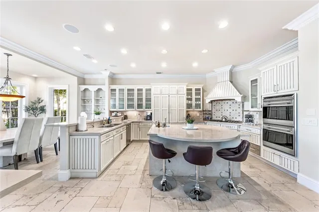 a kitchen with kitchen island granite countertop lots of counter top space and stainless steel appliances