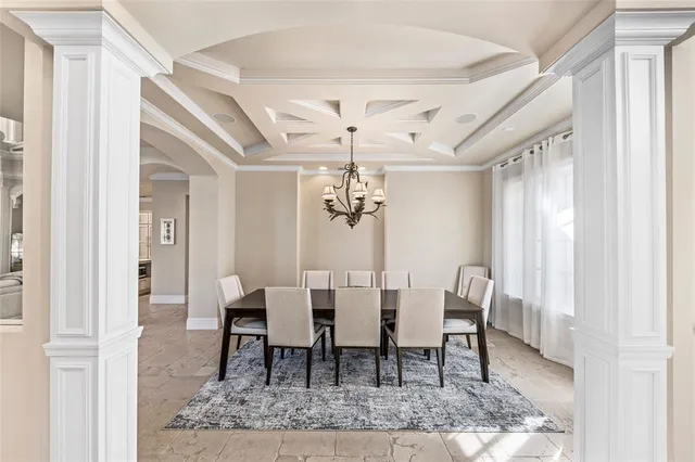 a view of a dining room with furniture and chandelier
