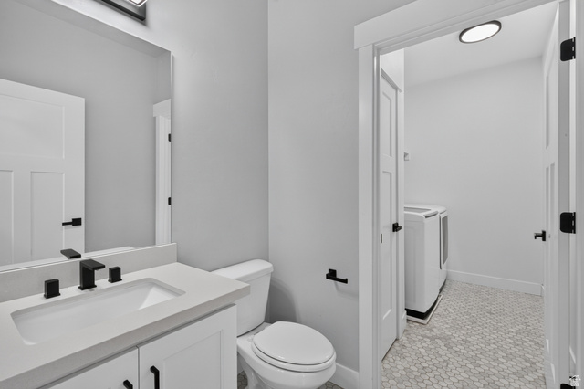 36 West Syracuse Road Vineyard, UT 84059 - Photo 20 of 56 Bathroom vanity featuring a rectangular integrated sink, light-toned countertop, and matte black faucet