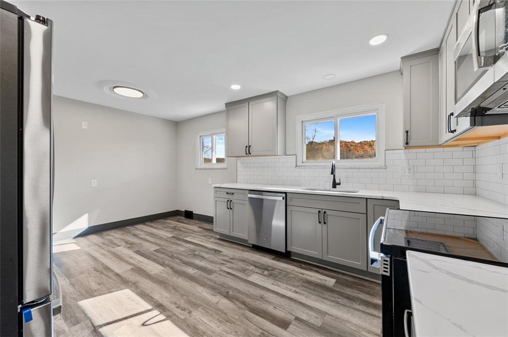 3767 Wiestertown Road Export, PA 15632 - Photo 16 of 34 a kitchen with granite countertop a sink stainless steel appliances and cabinets