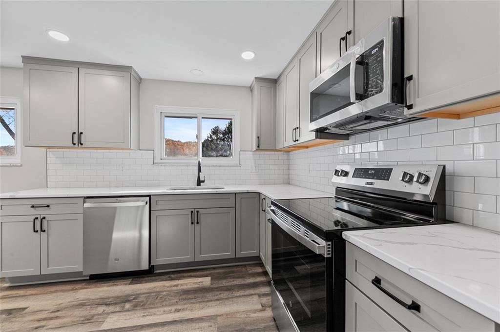 3767 Wiestertown Road Export, PA 15632 - Photo 17 of 34 a kitchen with stainless steel appliances a stove a sink and a microwave