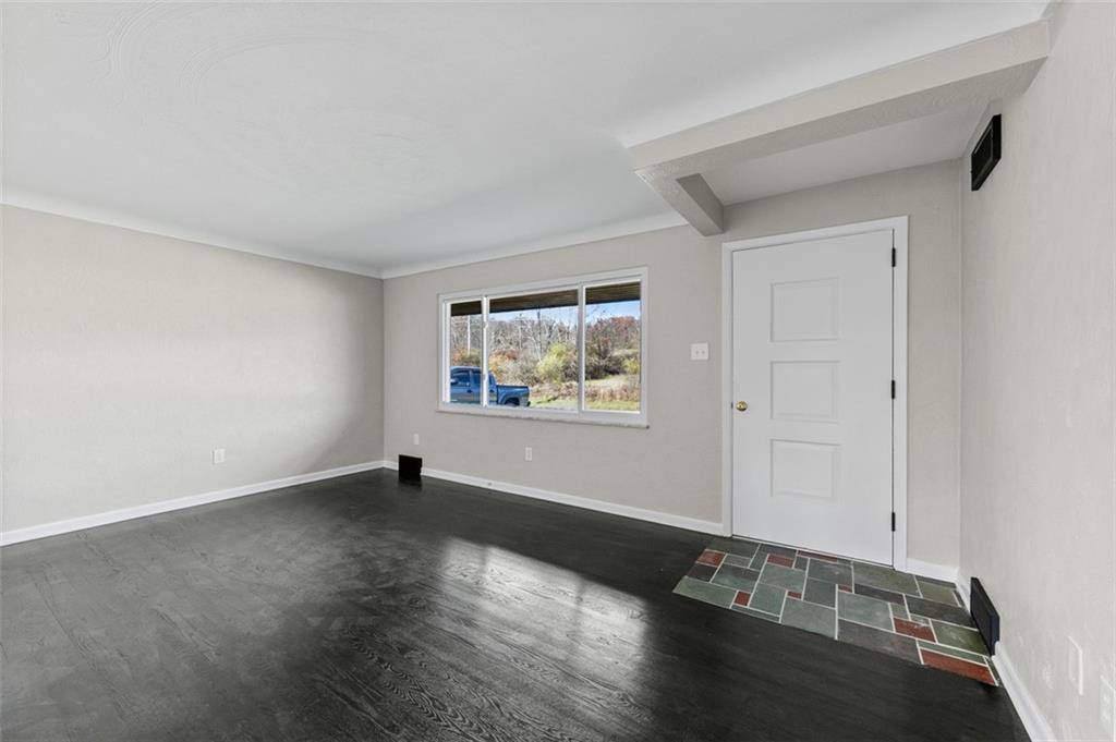 3767 Wiestertown Road Export, PA 15632 - Photo 9 of 34 a view of an empty room with wooden floor and a window
