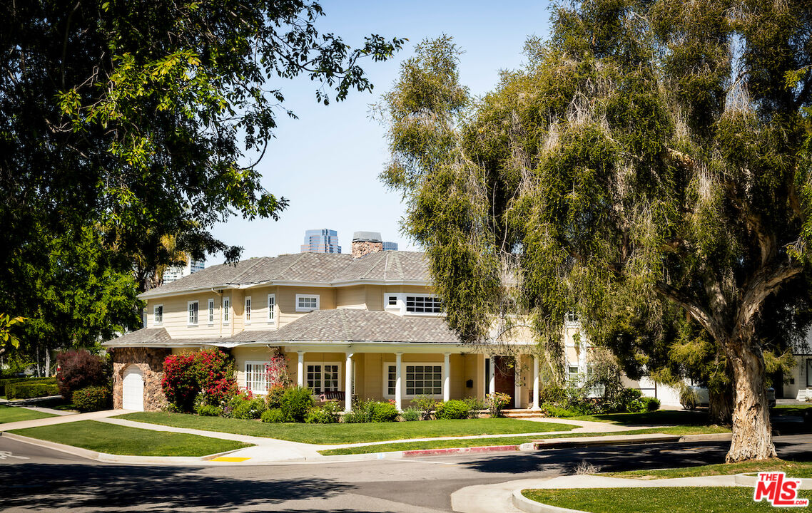 1629 Reeves Street Los Angeles, CA 90035 - Photo 2 of 7 a view of a white house with a big yard plants and large trees