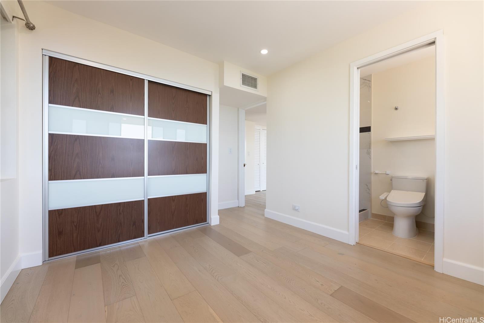1632 Ihiloa Loop Honolulu, HI 96821 - Photo 20 of 24 a view of an empty room with a cabinet and mirrors