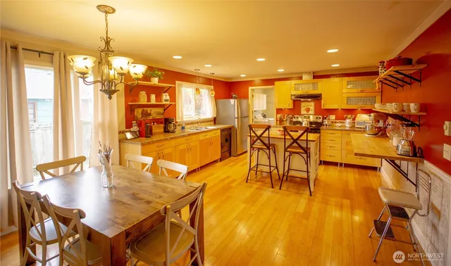 a view of a dining room with furniture and wooden floor