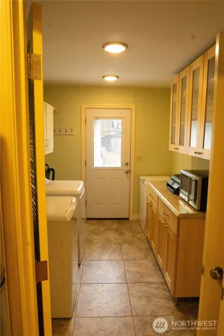a view of a bathroom with sink and washing machine