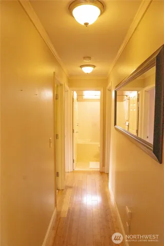 a view of empty room with wooden floor