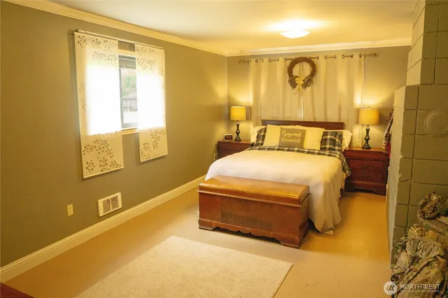 a bedroom with a bed and wall painting