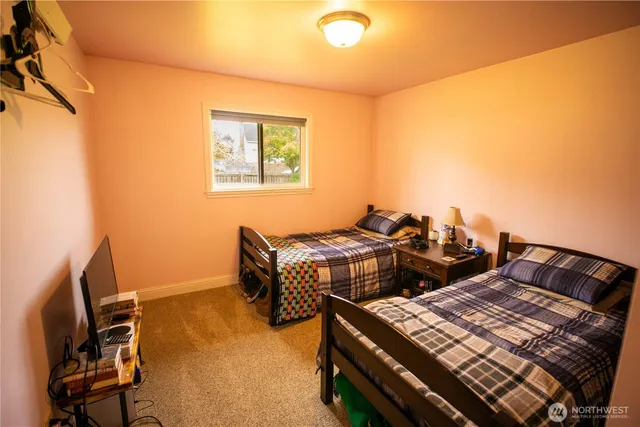 a bedroom with a bed and a desk