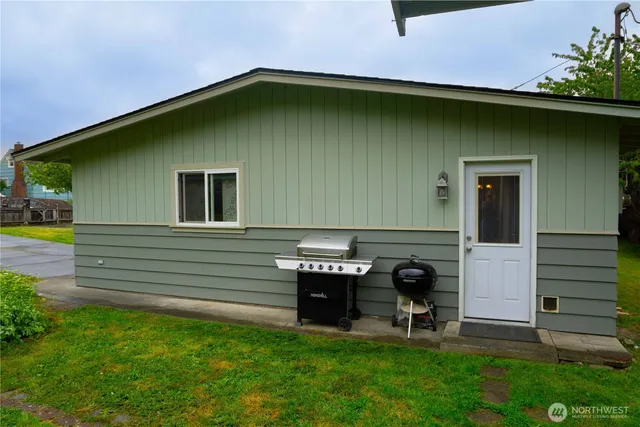 a backyard of a house with table and chairs