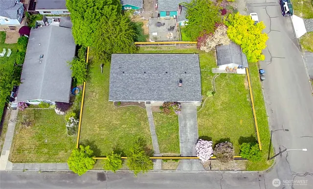 an aerial view of a residential houses with outdoor space