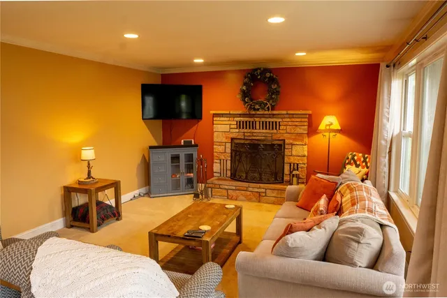 a living room with furniture a flat screen tv and a fireplace