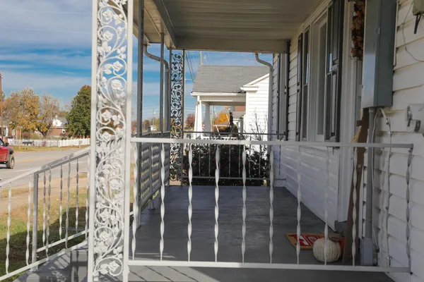 a view of a white house with lots of windows and plants