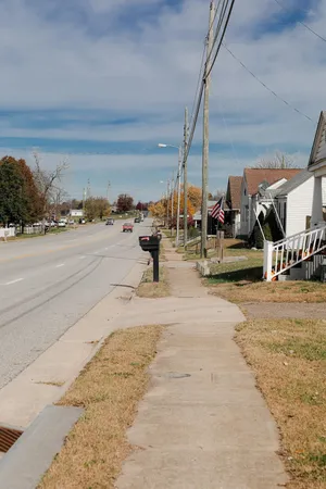 a front view of house with a garden