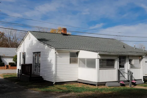 a view of a house with a yard and tree