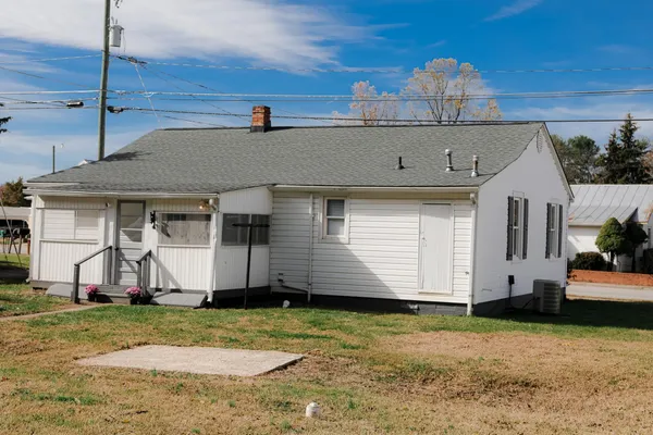 a kitchen with stainless steel appliances a stove top oven a refrigerator a sink and dishwasher with wooden floor