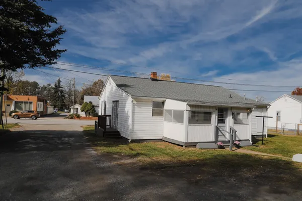 a large white kitchen with a refrigerator a stove a microwave and cabinets