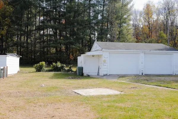 a kitchen with granite countertop a stove a sink and a refrigerator