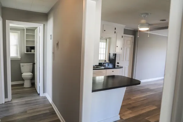 a view of a room with wooden floor and white walls