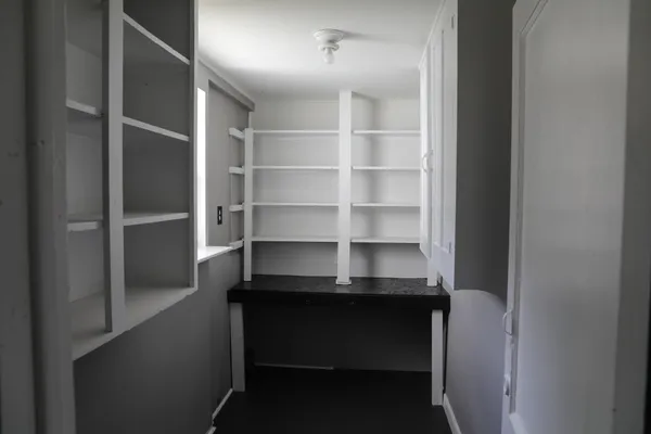 a view of a room with wooden floor