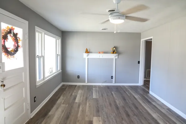 wooden floor in an empty room with a window