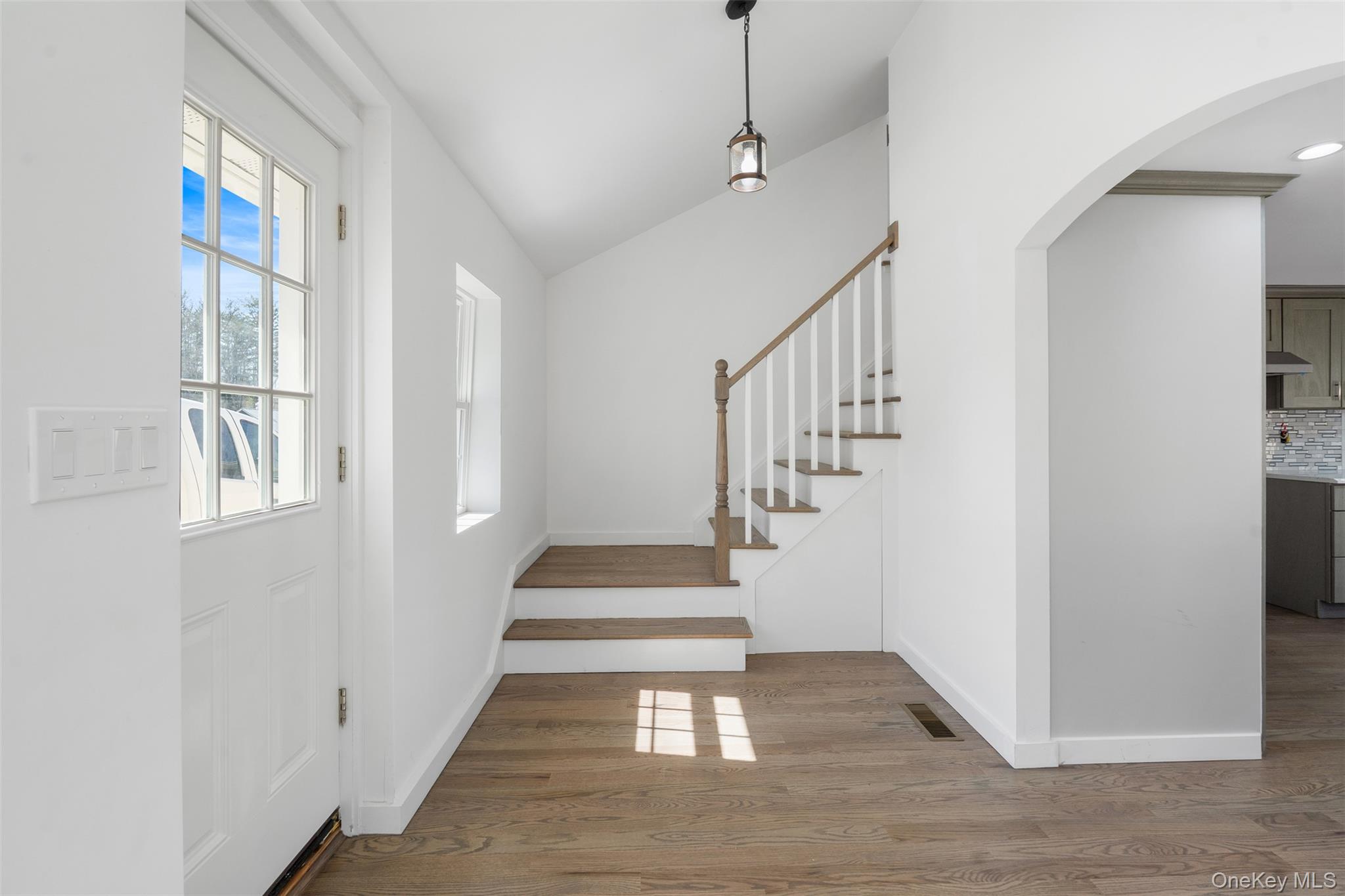 70 Barmore Road LaGrangeville, NY 12540 - Photo 6 of 47 Entrance foyer with wood finished floors, arched walkways, stairs, and lofted ceiling