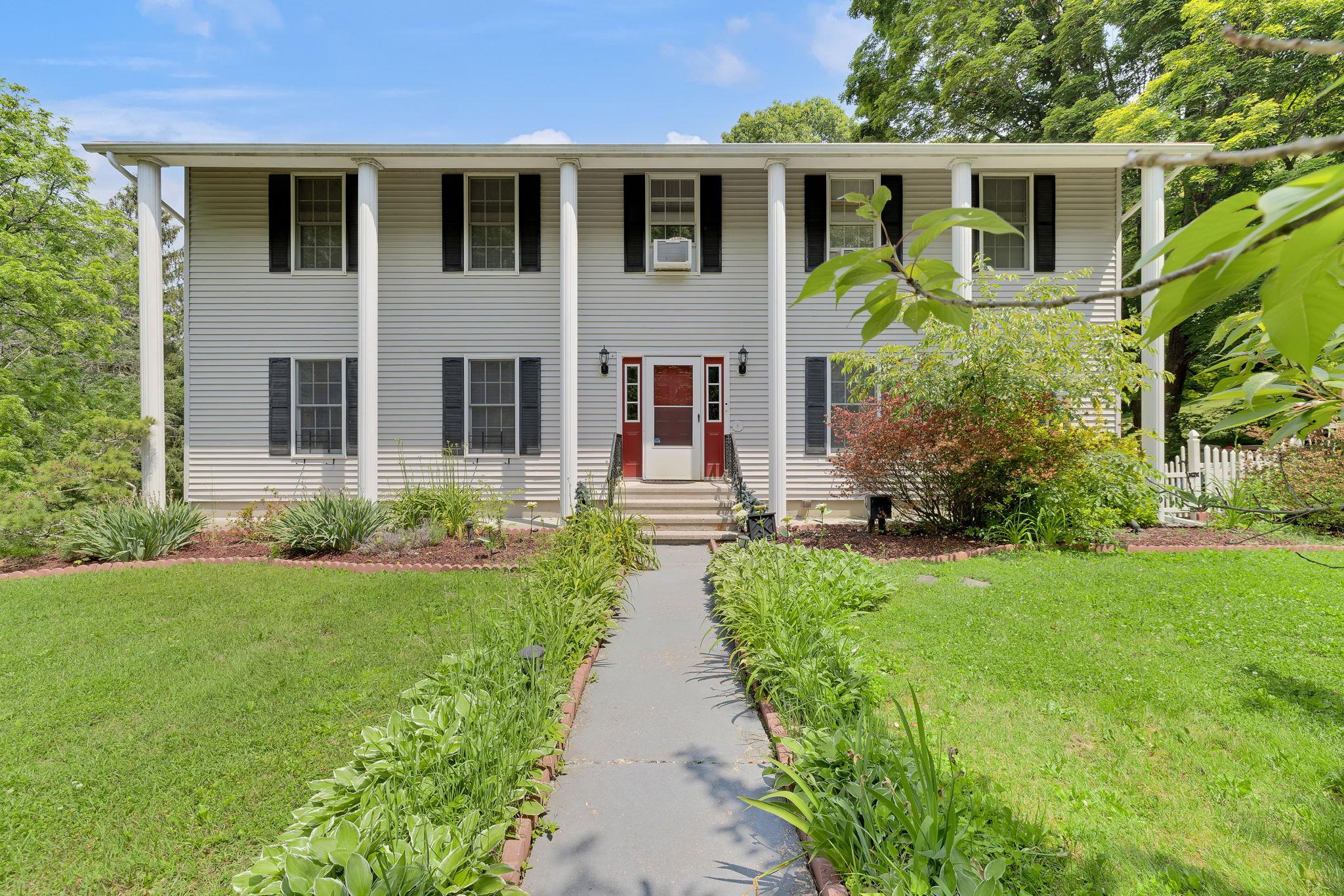 a front view of a house with garden